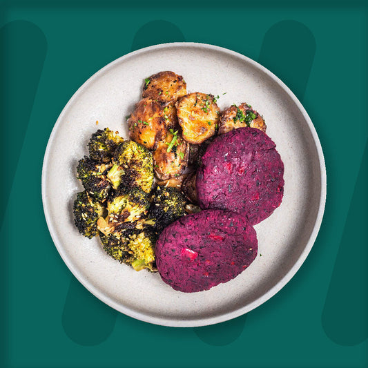  A colorful plate featuring shredded Mexican-spiced chicken garnished with fresh herbs, served alongside a portion of vibrant green cilantro rice. Complementing the dish is a side of roasted corn mixed with crumbled feta cheese, adding a touch of creaminess and texture. The meal is presented on a minimalist ceramic plate with a dark rim, set against a rich green background for a fresh and appetizing presentation. prepped meal.