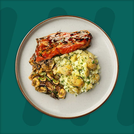  A colorful plate featuring shredded Mexican-spiced chicken garnished with fresh herbs, served alongside a portion of vibrant green cilantro rice. Complementing the dish is a side of roasted corn mixed with crumbled feta cheese, adding a touch of creaminess and texture. The meal is presented on a minimalist ceramic plate with a dark rim, set against a rich green background for a fresh and appetizing presentation. prepped meal.