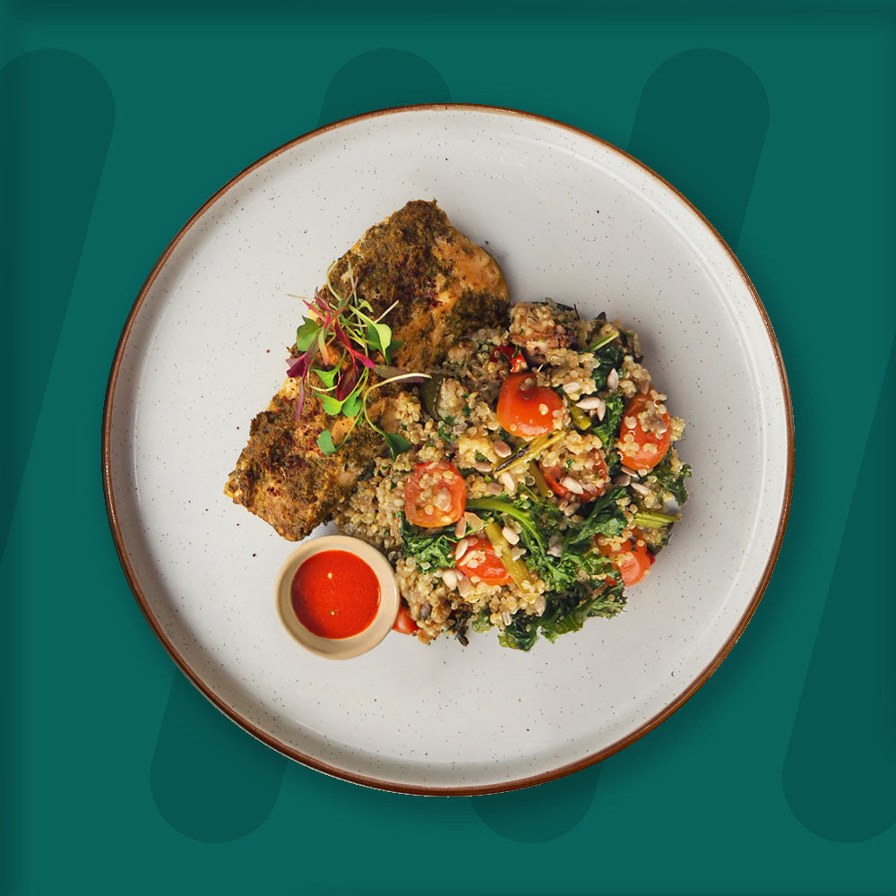  A colorful plate featuring shredded Mexican-spiced chicken garnished with fresh herbs, served alongside a portion of vibrant green cilantro rice. Complementing the dish is a side of roasted corn mixed with crumbled feta cheese, adding a touch of creaminess and texture. The meal is presented on a minimalist ceramic plate with a dark rim, set against a rich green background for a fresh and appetizing presentation. prepped meal.