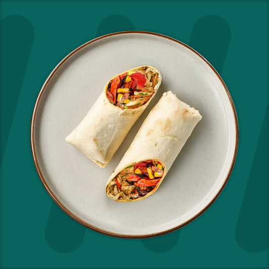  A colorful plate featuring shredded Mexican-spiced chicken garnished with fresh herbs, served alongside a portion of vibrant green cilantro rice. Complementing the dish is a side of roasted corn mixed with crumbled feta cheese, adding a touch of creaminess and texture. The meal is presented on a minimalist ceramic plate with a dark rim, set against a rich green background for a fresh and appetizing presentation. prepped meal.